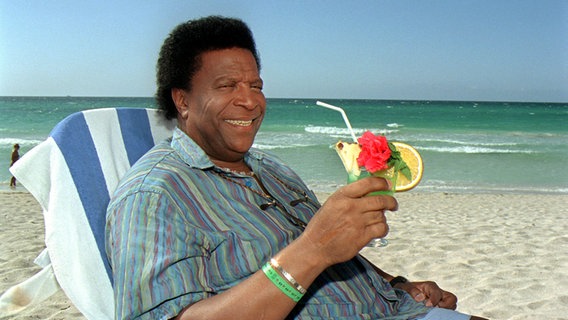 Einen tropischen Drink genießt Roberto Blanco am 16.5.2002 am Strand von Varadero. © dpa - Fotoreport Foto: Wolfgang Langenstrassen