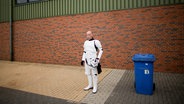 Ein als Stormtrooper verkleideter Fan macht beim Star Wars Fantreffen vor einer Messehalle in Essen eine Raucherpause. © picture alliance /dpa Foto: Rolf Vennenbernd
